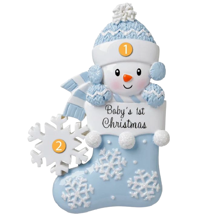 Cute snowman ornament wearing blue winter hat and scarf, holding stocking with "Baby's 1st Christmas" text, festive decor under 50 dollars