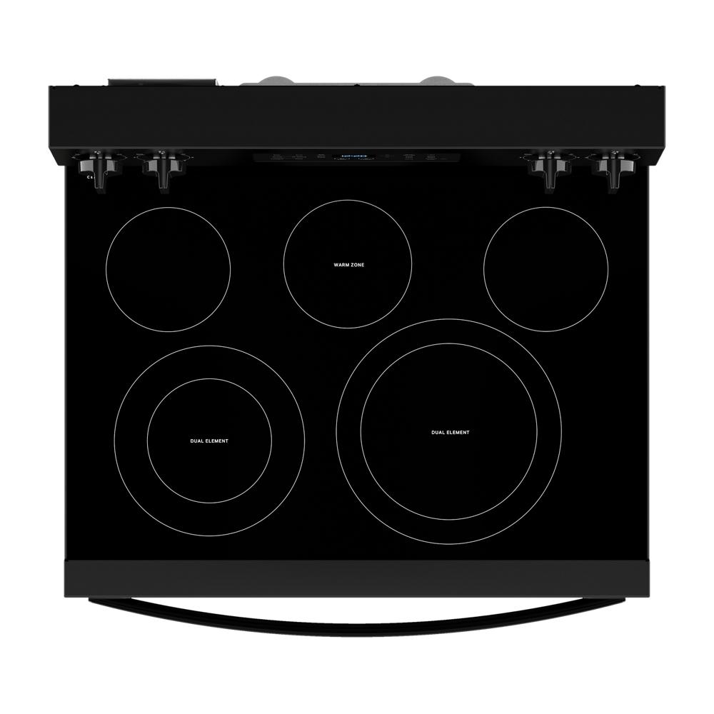 Top-down view of black electric range cooktop with five heating elements including dual elements and warm zone controls