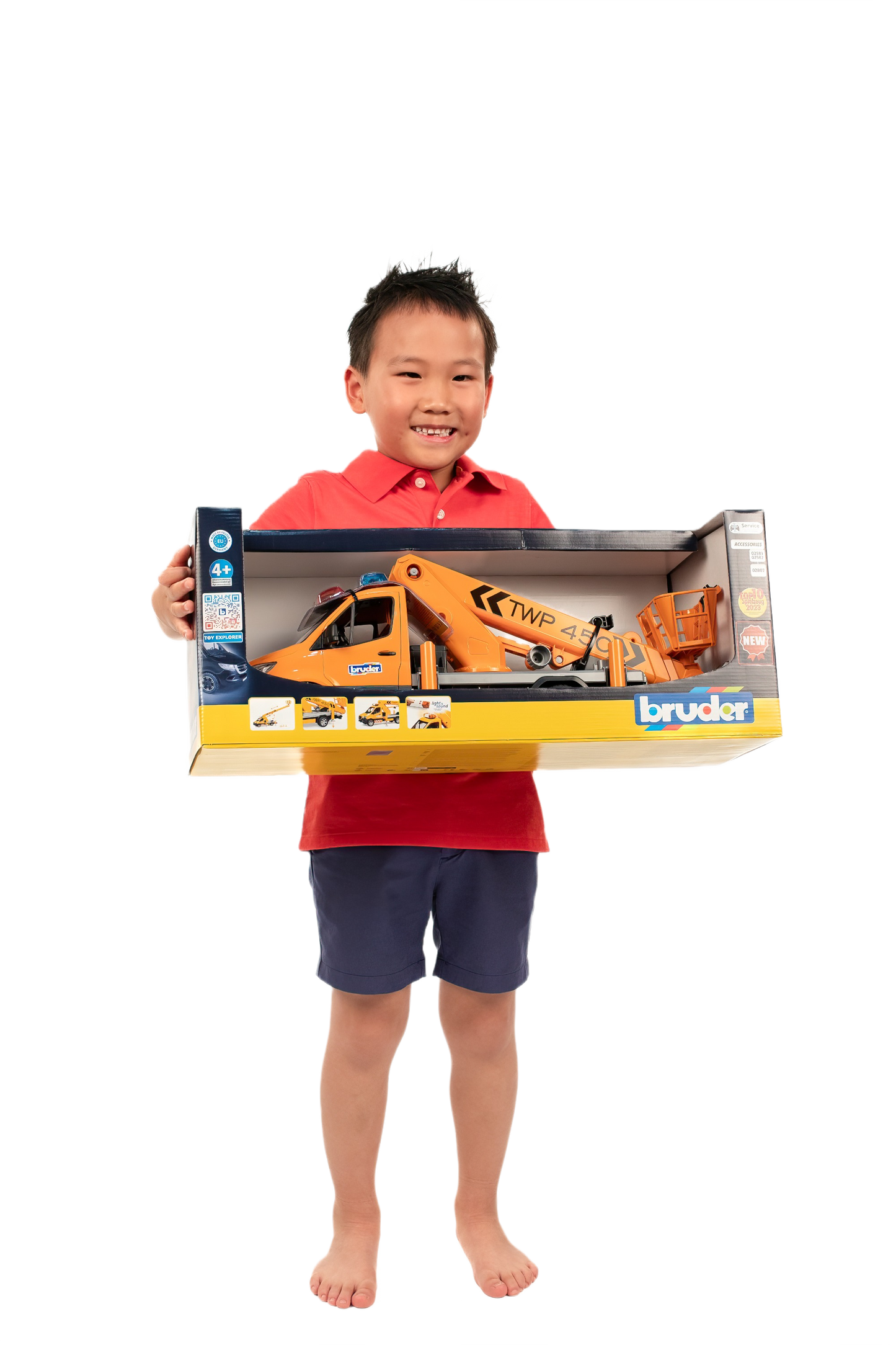 Child holding boxed orange toy truck with working platform and lifting module for home improvement play