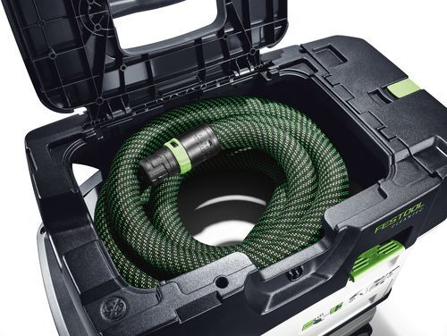 Green braided hose neatly coiled inside black modular carrying case for cordless dust extractor in tools and home improvement