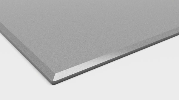 Close-up of titanium gray induction cooktop corner with smooth edge, part of modern kitchen appliances collection.