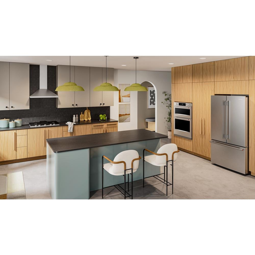 Modern kitchen with stainless steel wall-mount range hood and wood cabinetry in KitchenAid appliances collection