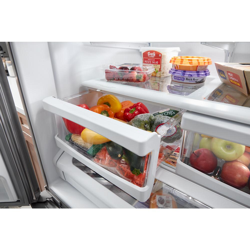 Open refrigerator drawer with fresh vegetables and clear compartments for kitchen and home improvement appliances