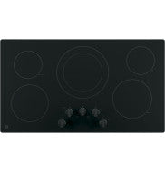 Black built-in electric cooktop with five cooking zones and front knob controls in kitchen appliances setting