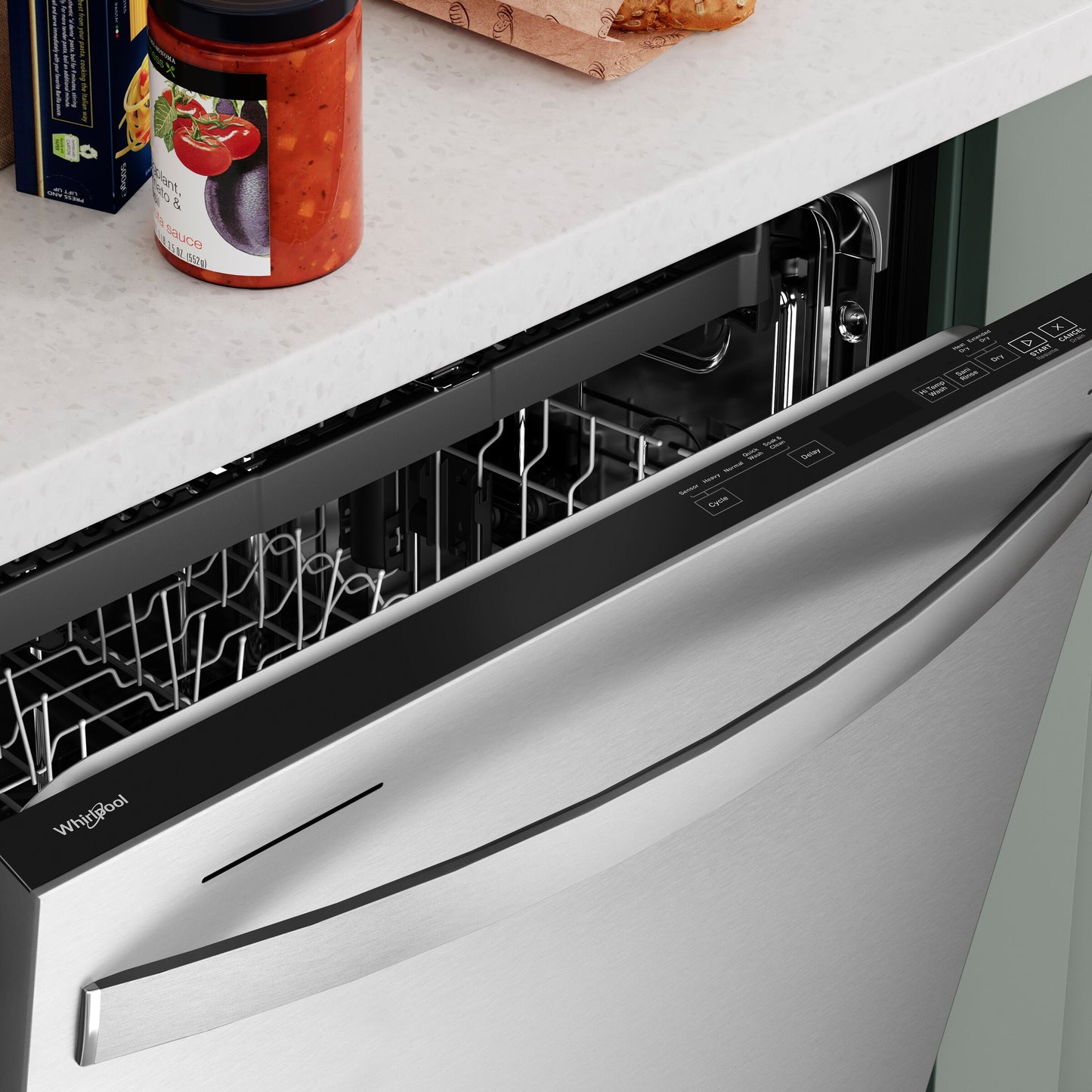 Partially open Whirlpool stainless steel dishwasher showing control panel and empty interior racks in kitchen setting