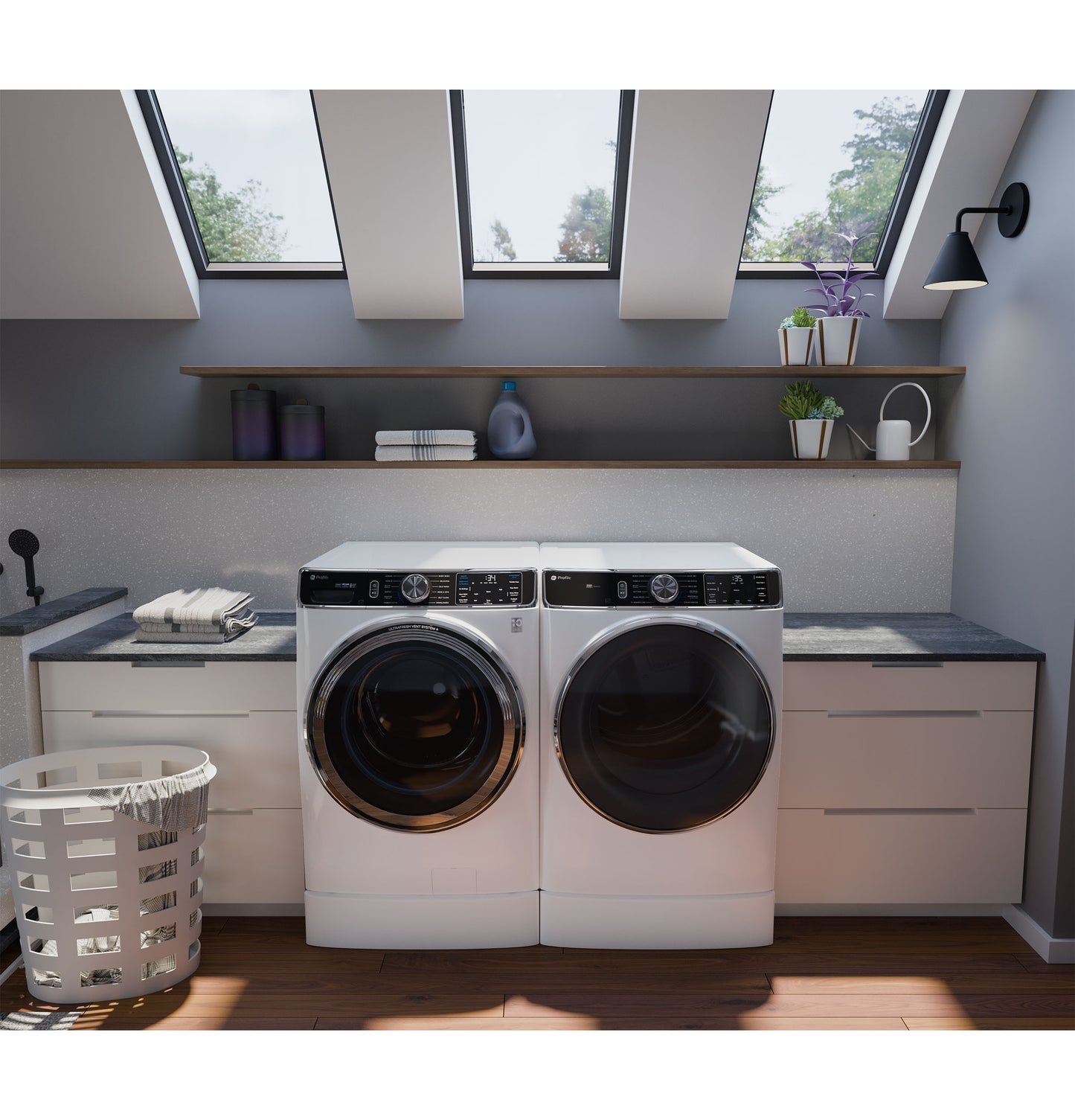 Modern laundry room with white smart front load washer and dryer under skylights and wooden shelves with plants and detergent