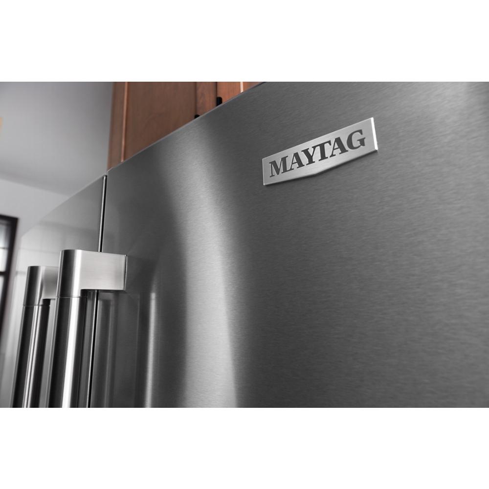 Close-up of fingerprint-resistant stainless steel French door refrigerator with brand name badge for home improvement and kitchen appliances