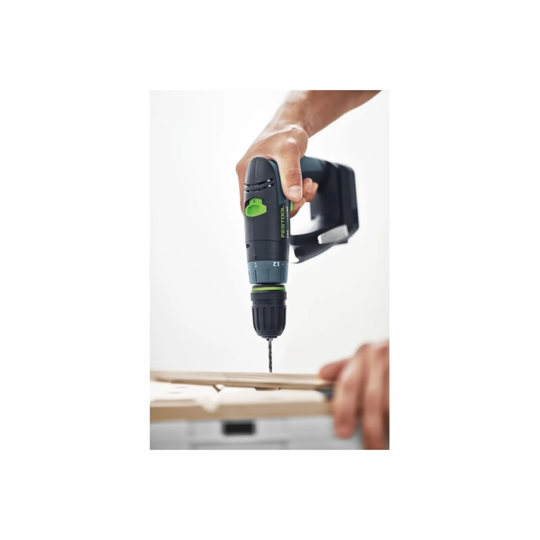 Cordless drill with a fine black and green centrotec HSS drill bit driving into wood for home improvement tasks