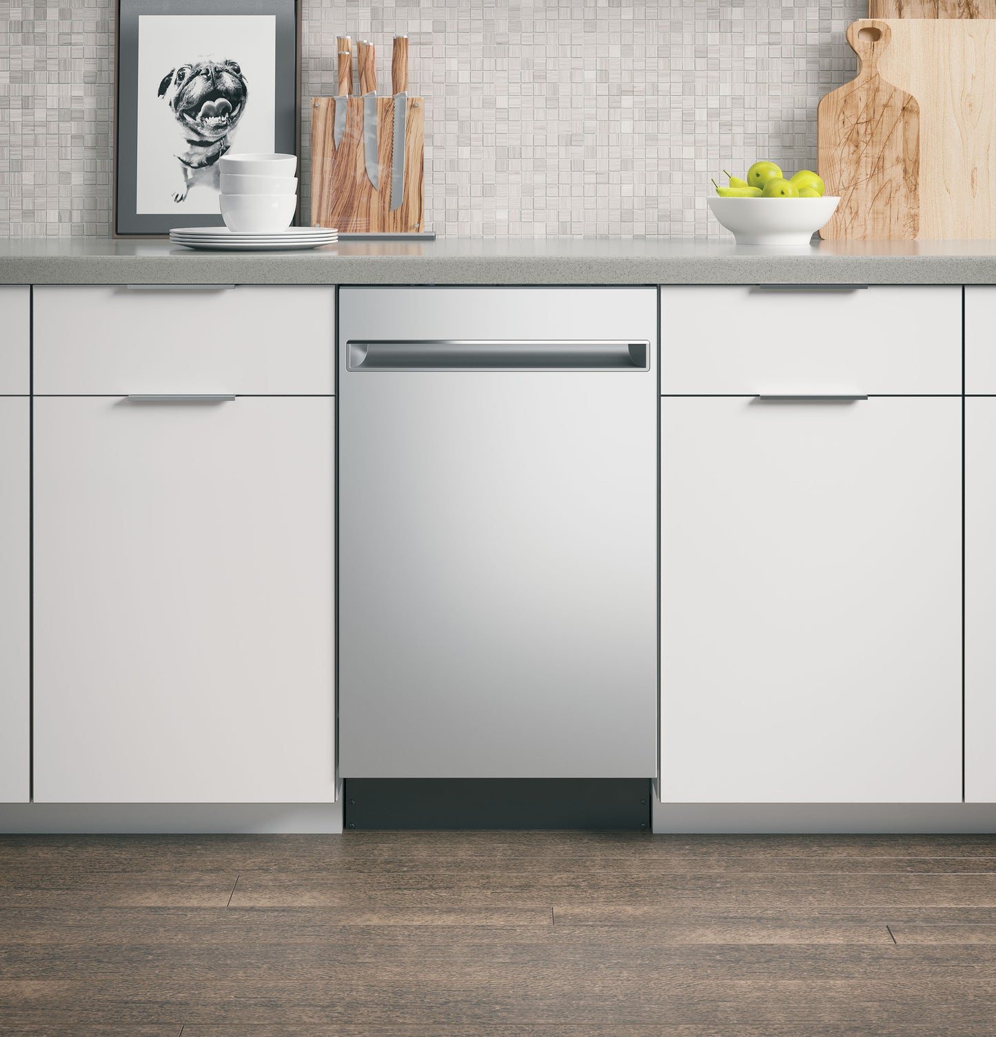 Built-in stainless steel dishwasher integrated into modern kitchen with white cabinetry and mosaic tile backsplash from Appliances collection
