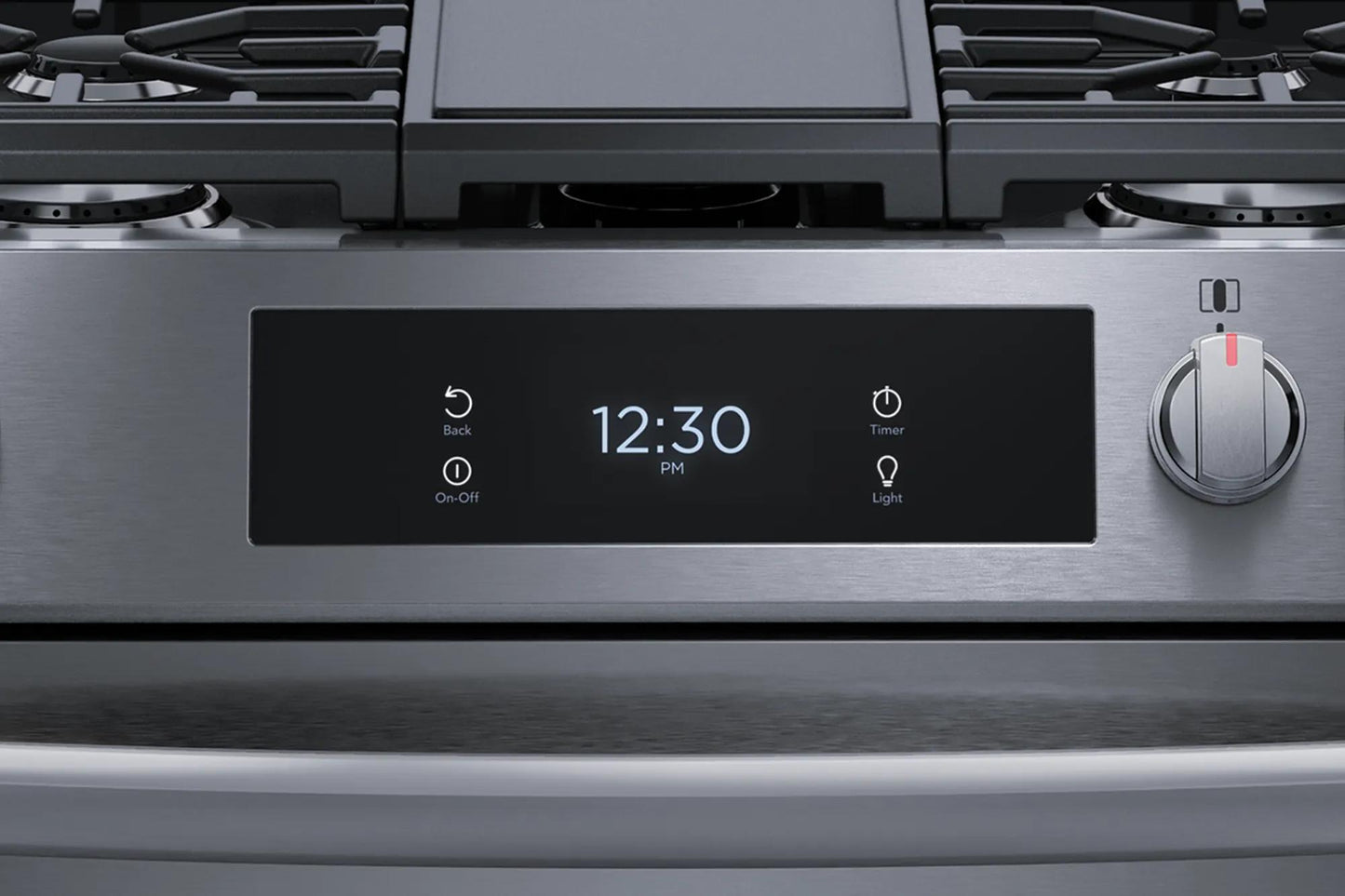 Close-up of stainless steel gas range control panel with digital clock, timer, light buttons, and single control knob