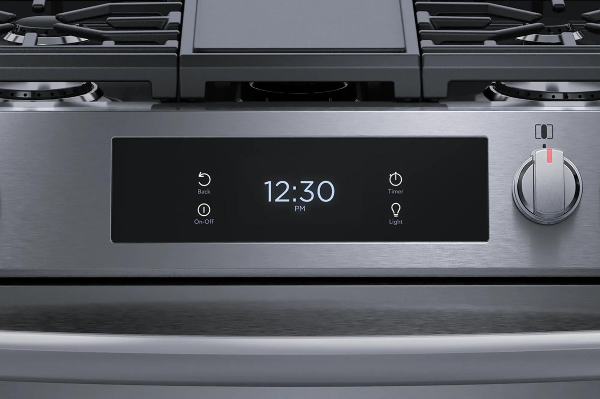 Close-up of stainless steel gas range control panel with digital clock, timer, light buttons, and single control knob