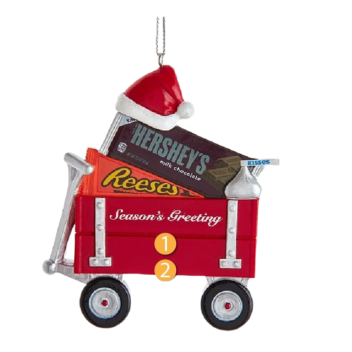 Red wagon ornament filled with Hershey's, Reese's, and Kisses chocolates wearing a Santa hat for holiday décor