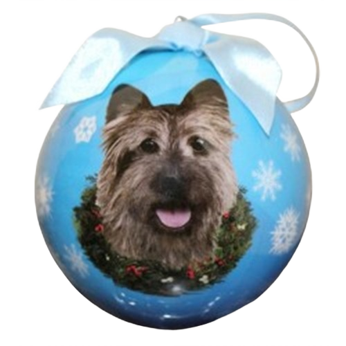 Blue Christmas ball ornament with Cairn Terrier face surrounded by wreath and white snowflakes decoration