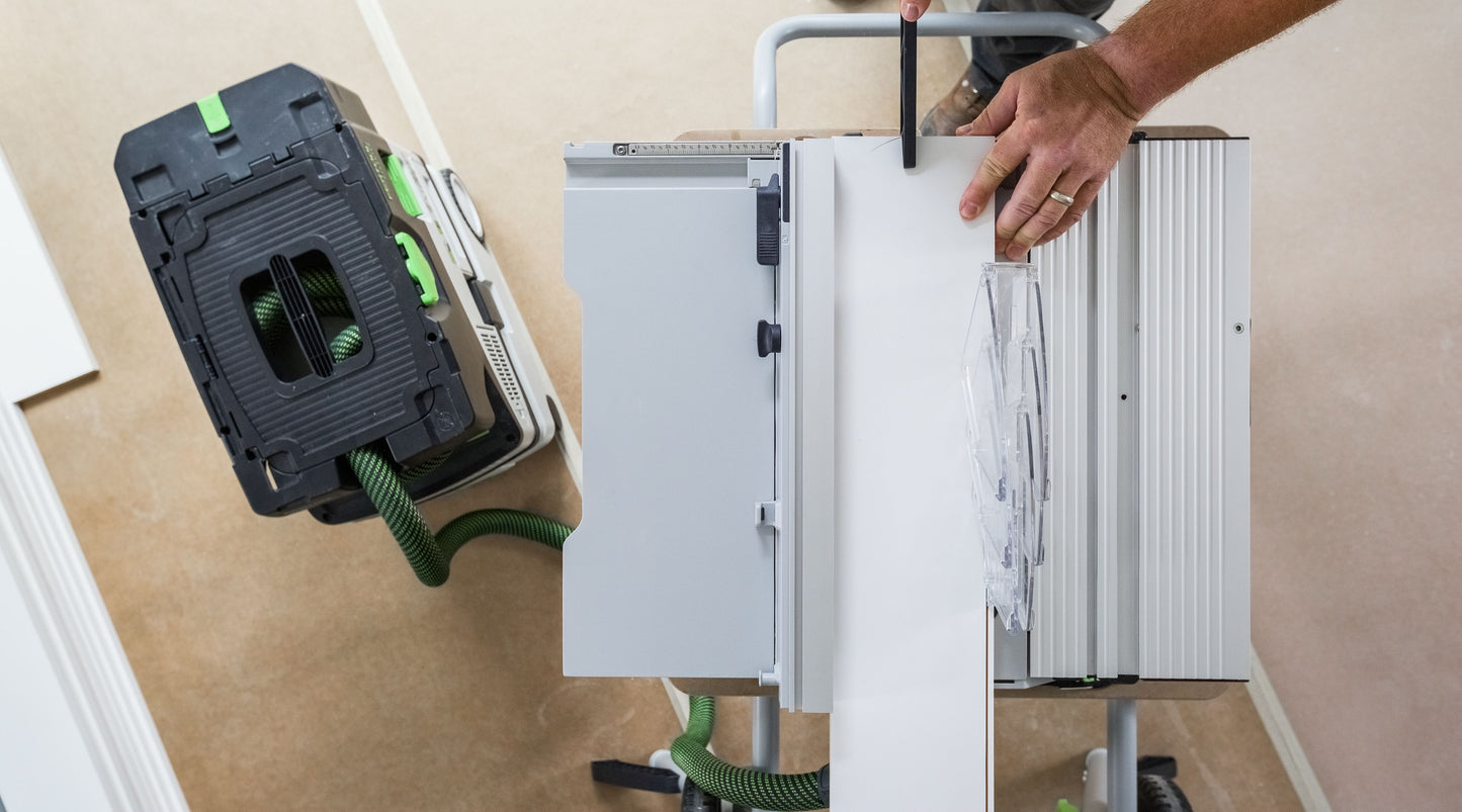 Portable cordless table saw being operated with dust extraction system connected, in power tools collection
