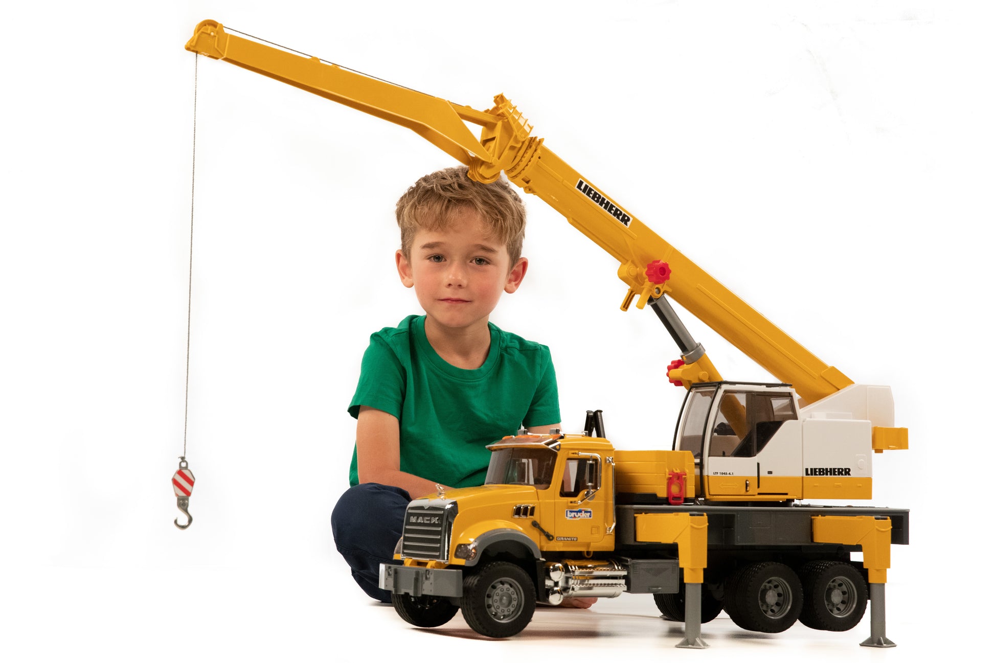 Child playing with Bruder MACK Granite Liebherr crane truck model in Vehicles & Remote Controlled Toys collection