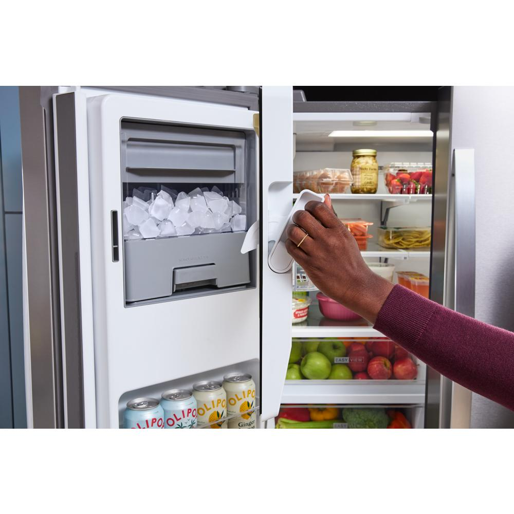 Person opening stainless steel 36-inch wide true counter depth French door refrigerator with organized interior shelves