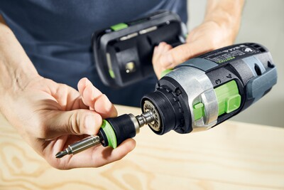 Hand installing a Festool Centrotec impact bit holder into a cordless drill, part of power tool accessories for home improvement.