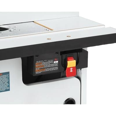 Close-up of power switch and warning label on Bosch laminated cabinet style router table for woodworking tools