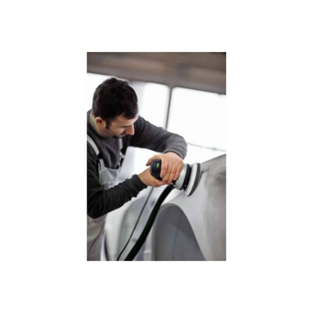 Man using a power sander with a supersoft interface pad for smoothing a vehicle surface in a workshop.