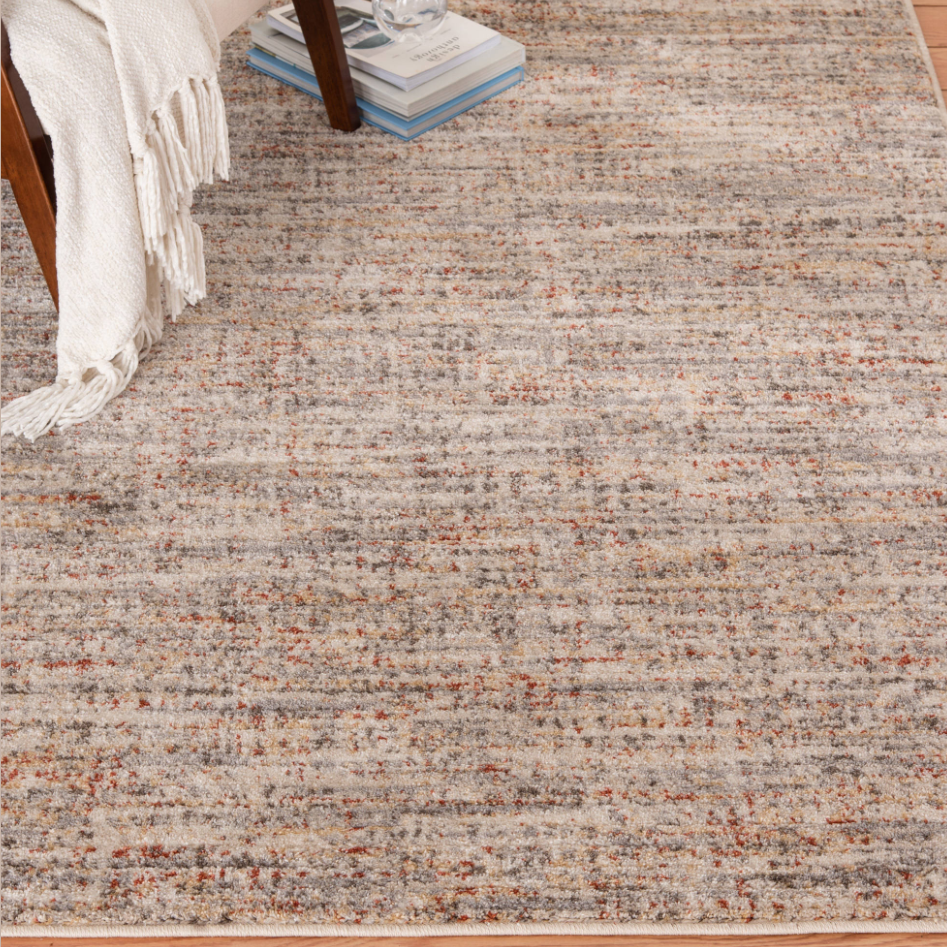 Area rug with soft neutral tones of cream, rust, blue, yellow, and green for home decor and flooring collections
