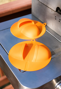 Bright orange heat-resistant silicone grill mitts designed for safe outdoor grilling and cooking protection under $50 collection