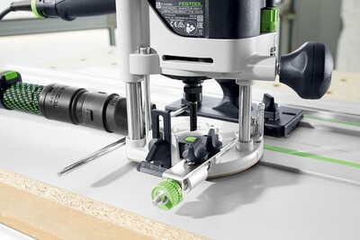 Festool router mounted on guide rail with dust extraction hose for precise woodworking tool use and home improvement tasks