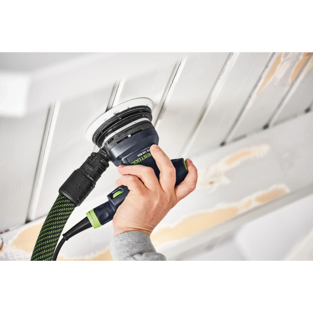 Hand holding Festool sanding tool with supersoft StickFix sanding pad on wood ceiling, woodworking tool accessory