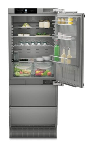 Built-in stainless steel bottom mount refrigerator with open door showing organized interior and vegetable drawers in Appliances collection