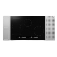 Black glass 30-inch induction cooktop with four cooking zones and touch controls in kitchen appliances collection