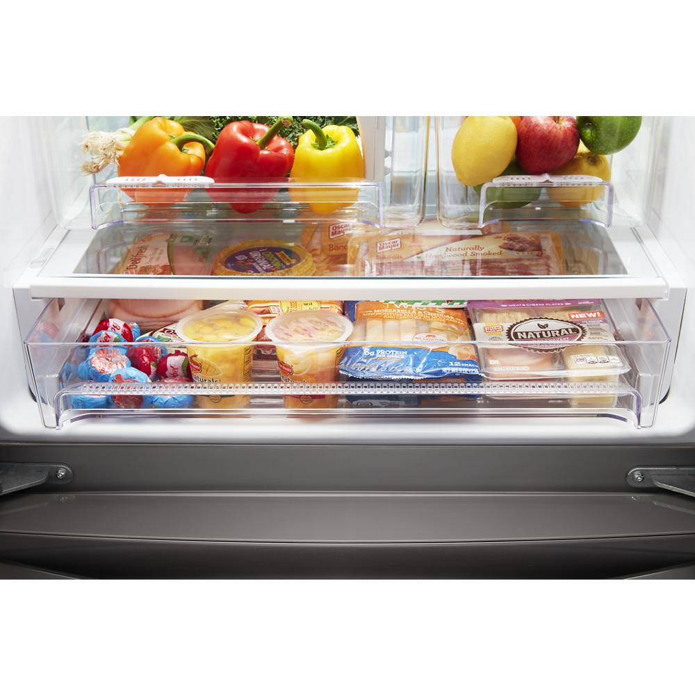 Open refrigerator drawer showing organized food storage with fresh produce, dairy, and packaged items in appliance collection