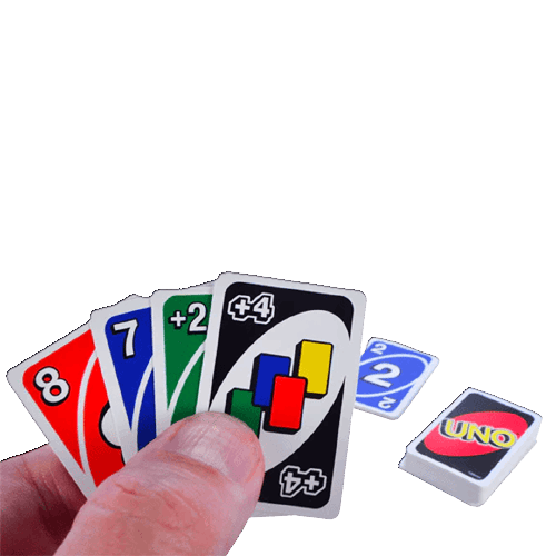 Hand holding colorful miniature cards including action and number cards from a compact UNO game in toys collections under $50