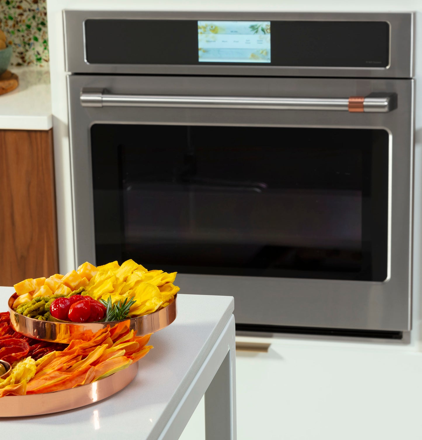 Stainless steel smart convection wall oven with touchscreen display in modern kitchen and appliances setting