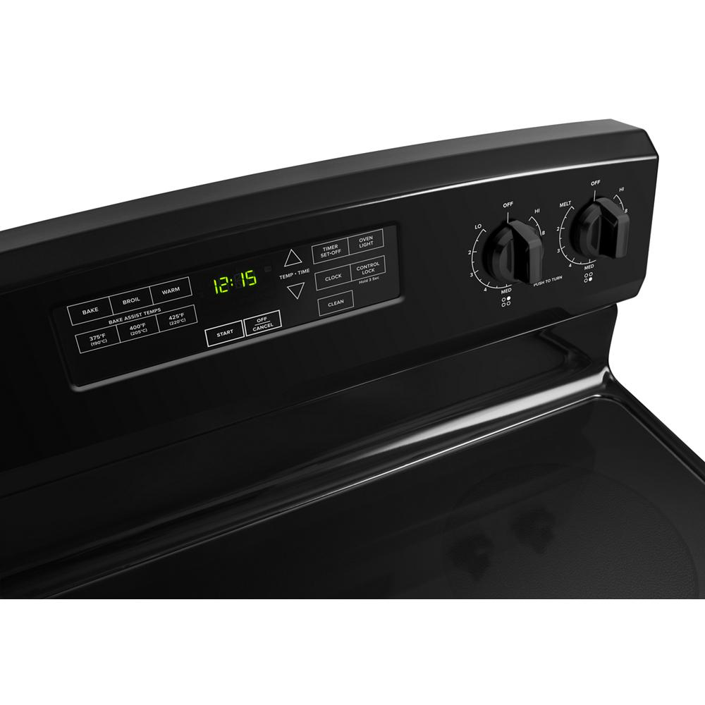 Close-up of black electric range control panel with digital clock, electronic buttons, and two large heat knobs from kitchenware collection