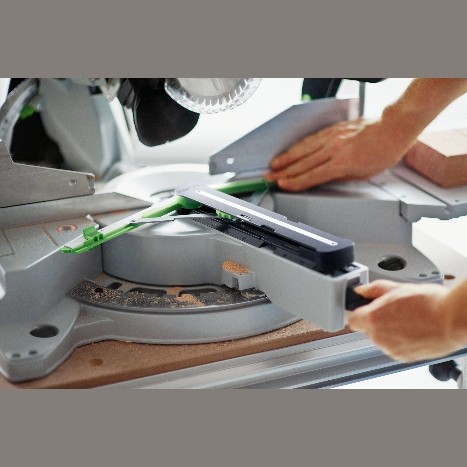 Hands adjusting a miter angle transfer tool on a saw base for precise angle measurement in tool accessories collection