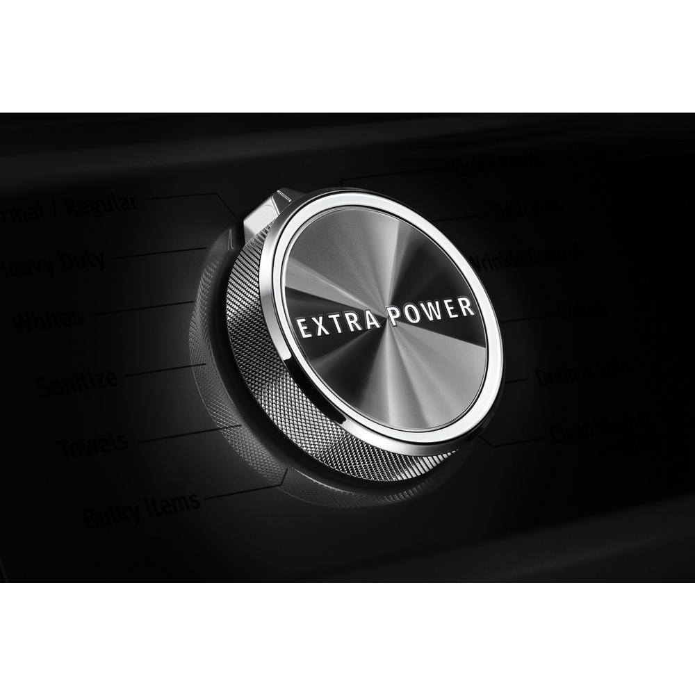 Close-up of stainless steel control knob labeled Extra Power on front load washer in appliances collection