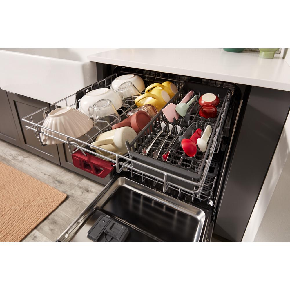 Open kitchen dishwasher with upper rack loaded with bowls, cups, and organized cutlery in modern kitchen setting