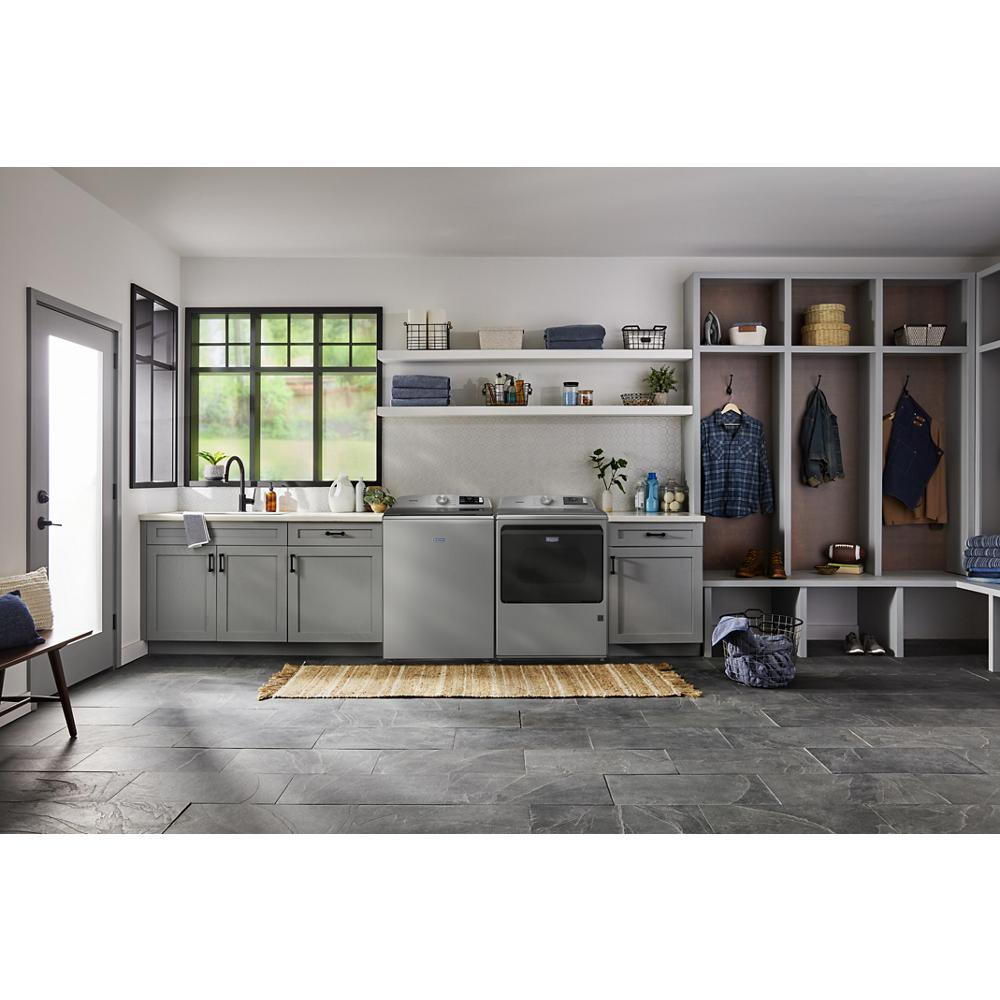 Laundry room with gray cabinetry, stainless steel top load gas dryer and matching washer from Dryers collection