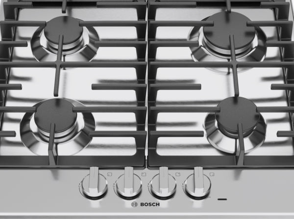 Stainless steel cooktop with four gas burners, cast iron grates, and metal knobs in Bosch kitchen appliances collection