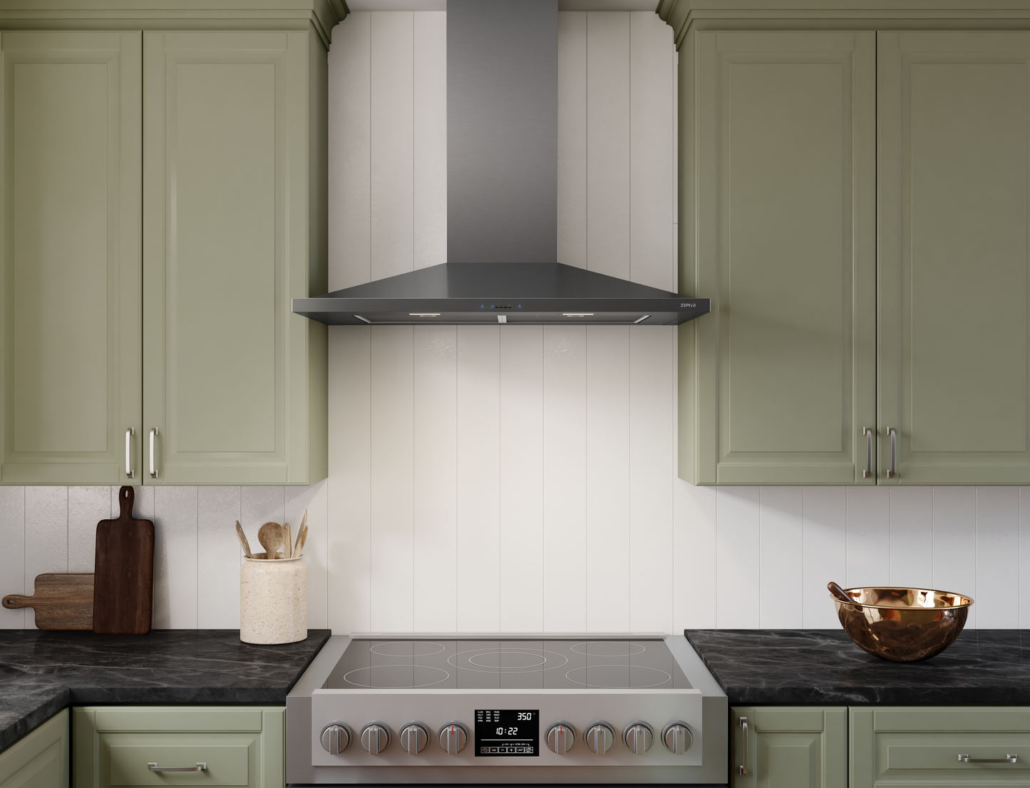 Black stainless steel chimney hood with LED lights above modern electric range in kitchen with green cabinetry
