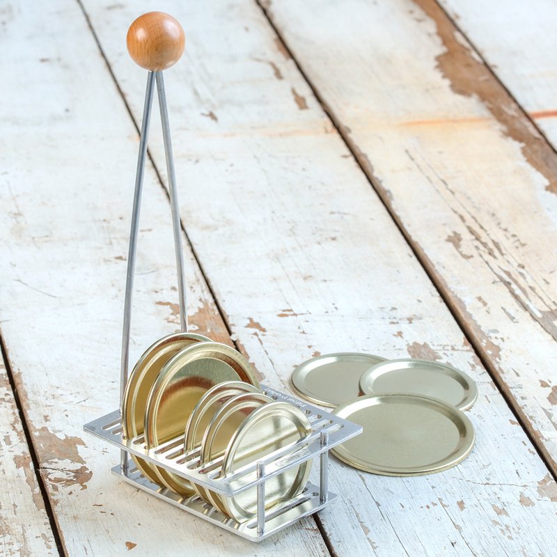 Metal rack with wooden knob for holding and sterilizing various sizes of canning lids during home food preservation
