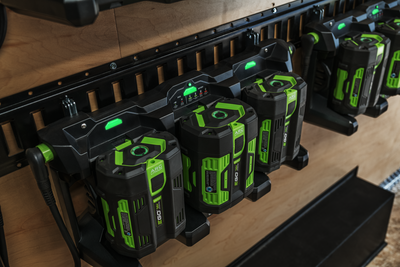 Three-port charging dock with green-accented power tool batteries in portable power and tool accessories collection