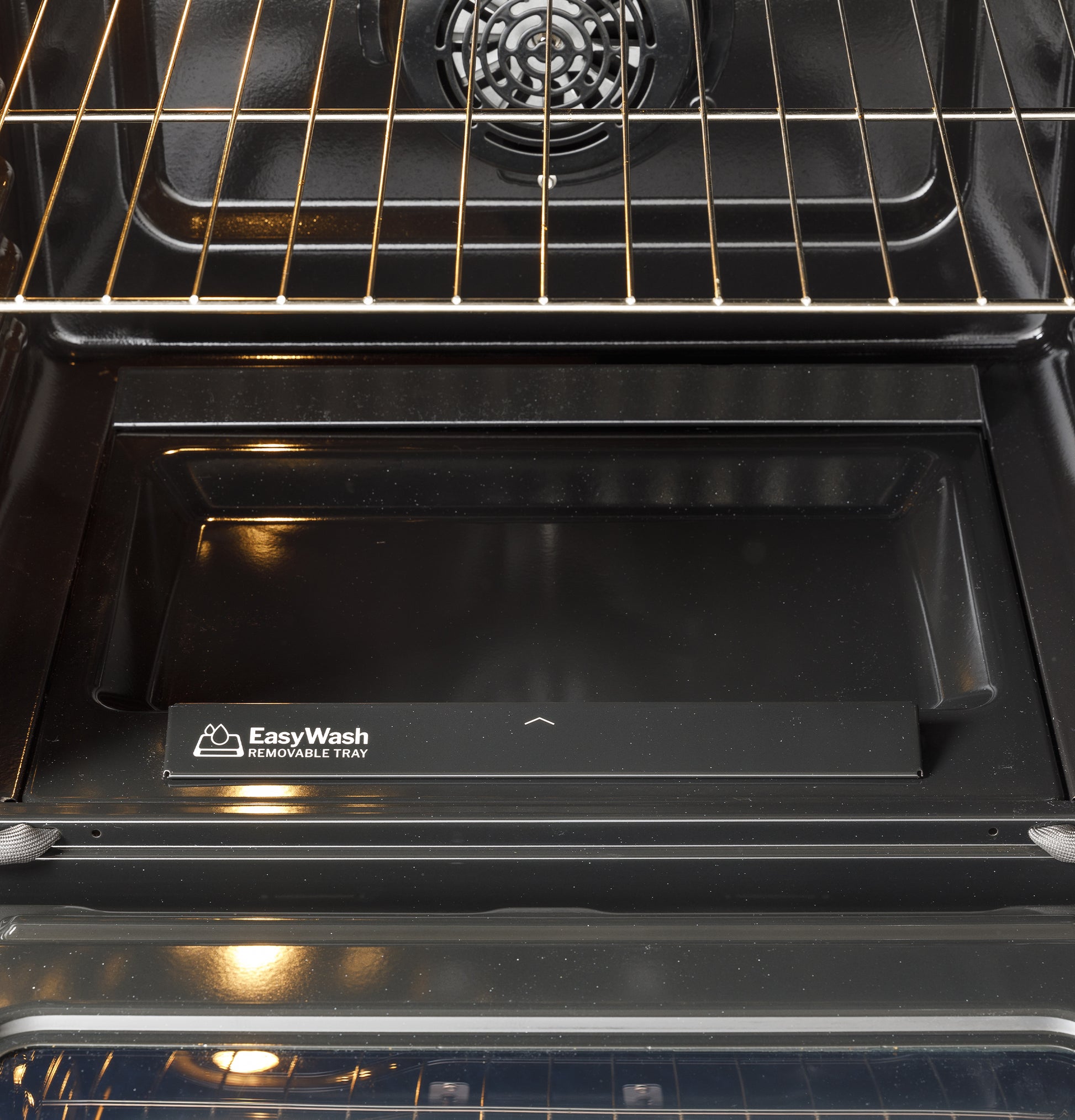 Interior of black gas convection range oven featuring EasyWash removable tray and metal oven rack in kitchen appliances collection