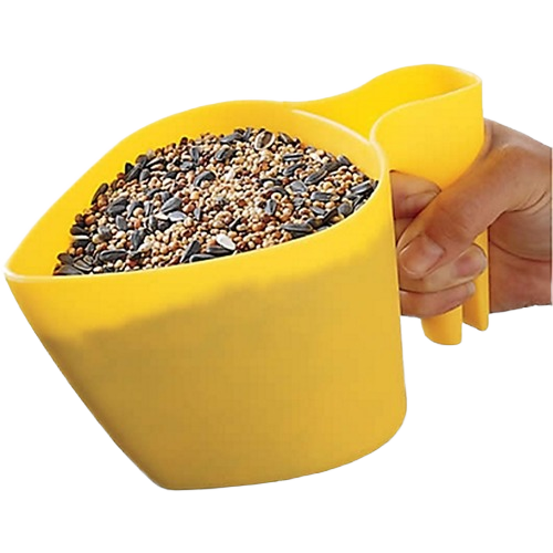 Yellow scooper filled with mixed bird seeds held by a hand, designed for easy filling and pouring tasks