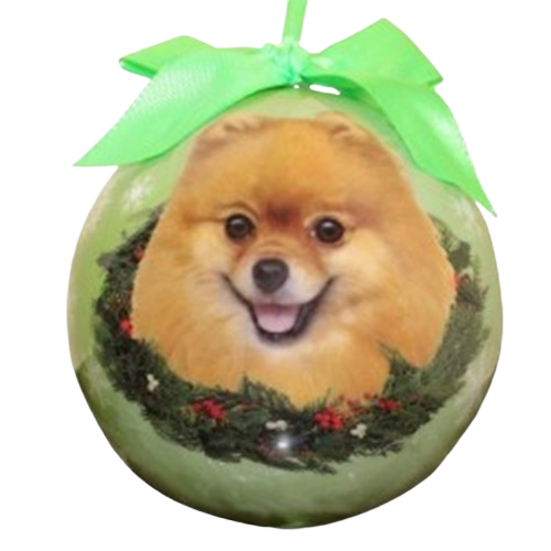 Christmas ball ornament featuring a smiling Pomeranian face with decorative wreath and green ribbon bow