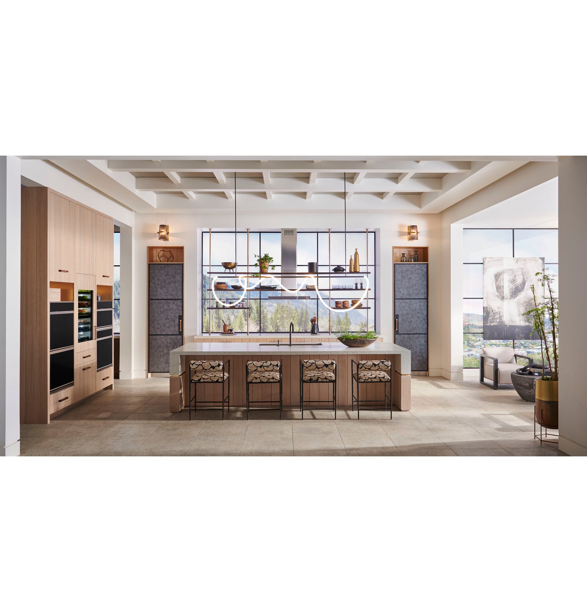 Contemporary kitchen featuring Monogram 30" minimalist double wall ovens with large island and scenic window views in appliances collection