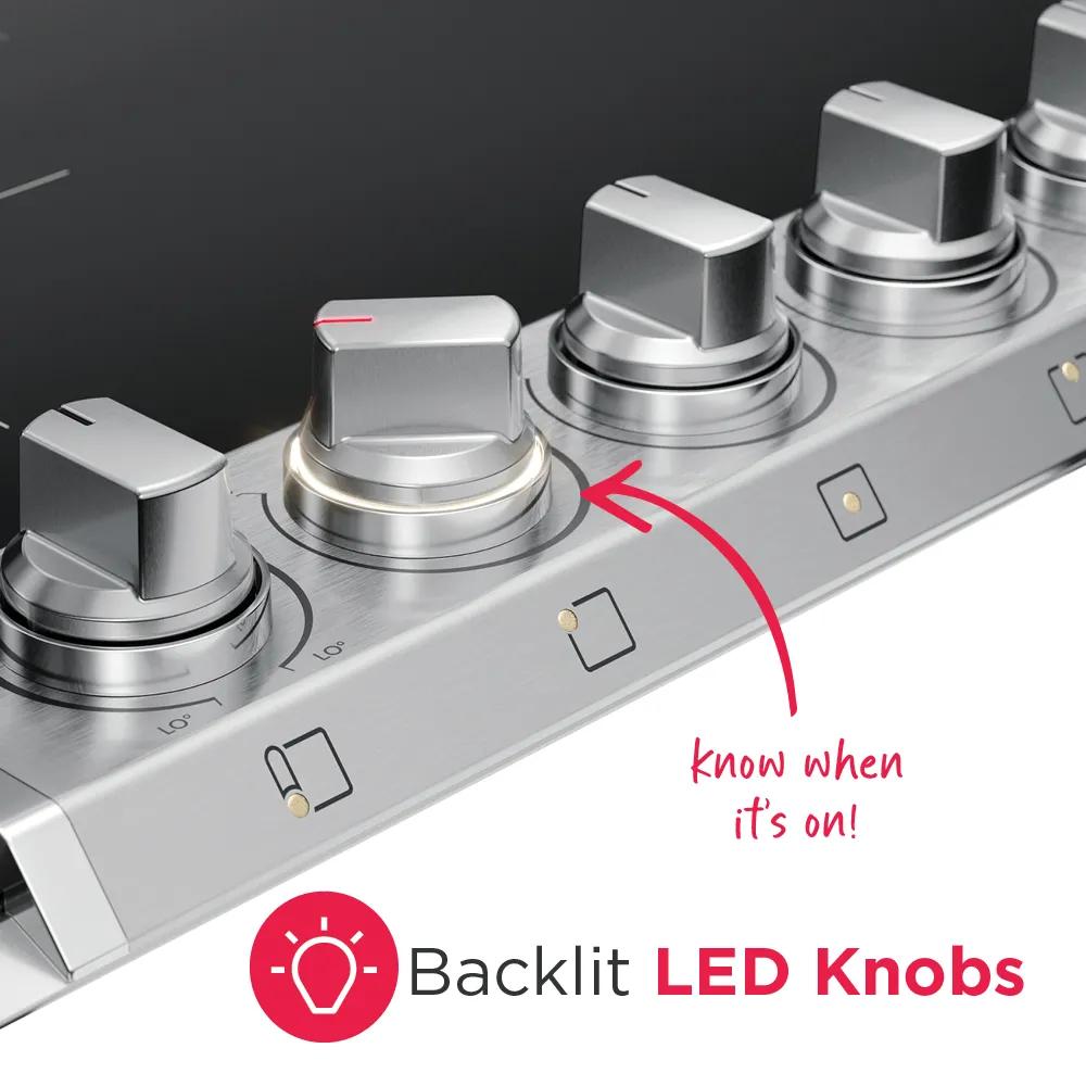 Close-up of stainless steel backlit LED control knobs on induction cooktop with black glass surface and labeled indicators
