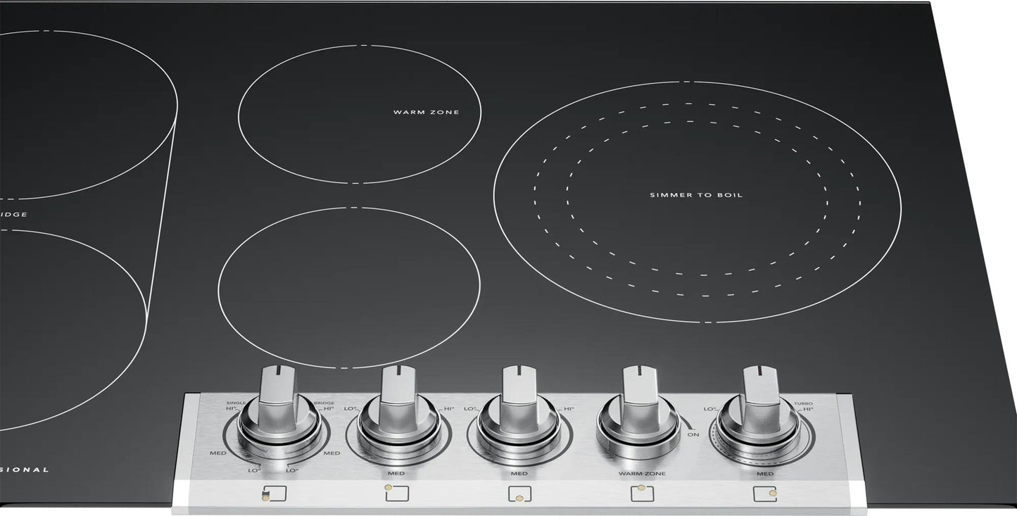 Black radiant electric cooktop with five metallic control knobs and bridged heating element from cooktops collection
