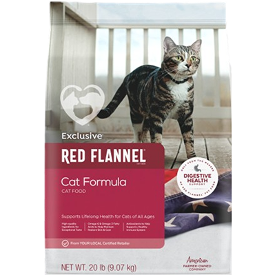 Bag of exclusive red flannel cat formula dry food with a tabby cat standing on wooden floor.