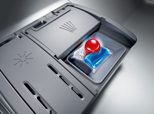Close-up of dishwasher detergent compartment with liquid and gel pods inside a stainless-steel dishwasher from Kitchen & Kitchenware collection