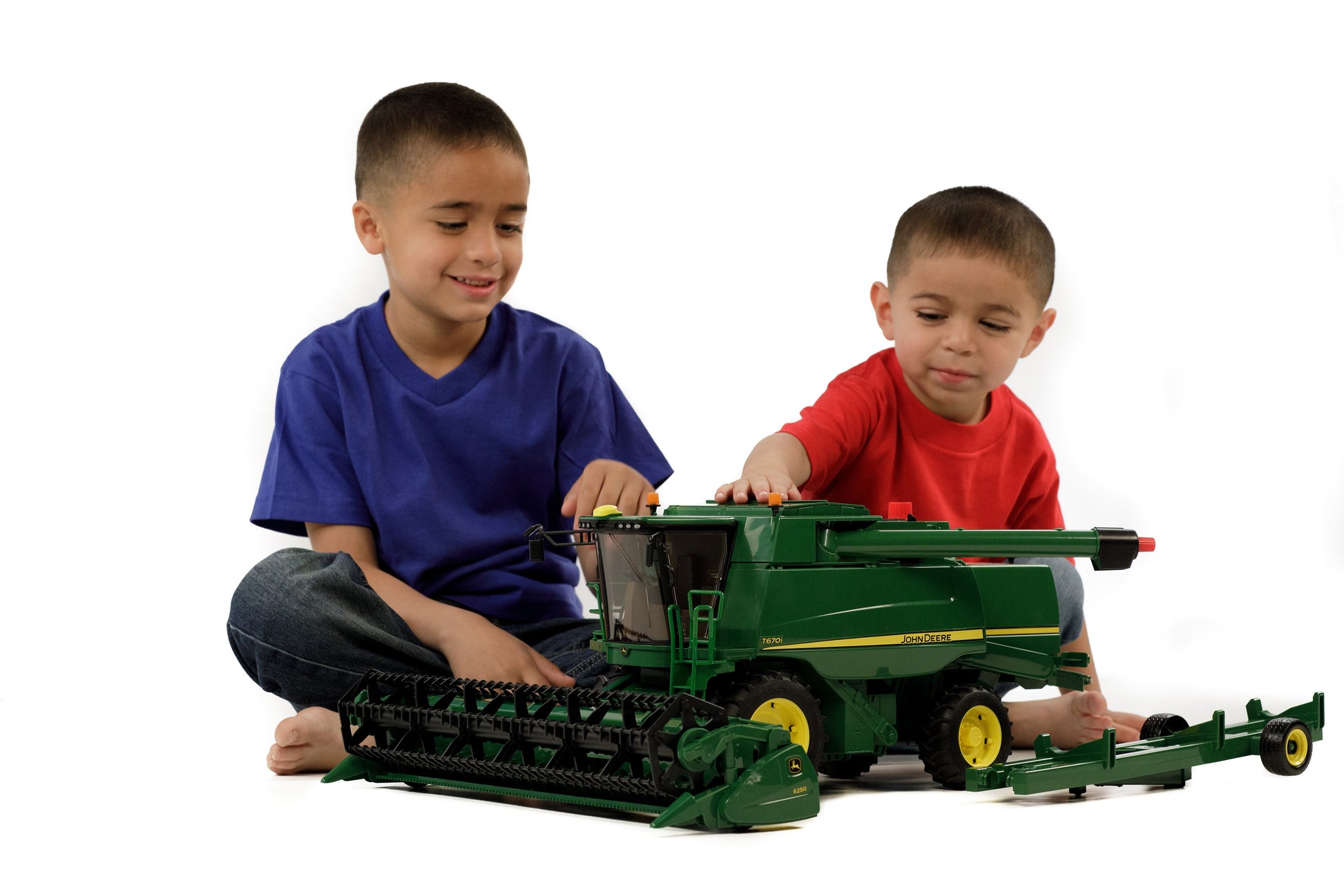 Two boys playing with a detailed Bruder green toy combine harvester in Vehicles & Remote Controlled Toys collection